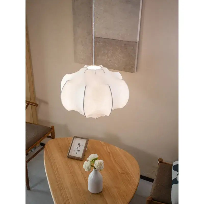 A soft white petal-shaped pendant light with subtle black outline from decorbites italian silk pendant lights collection