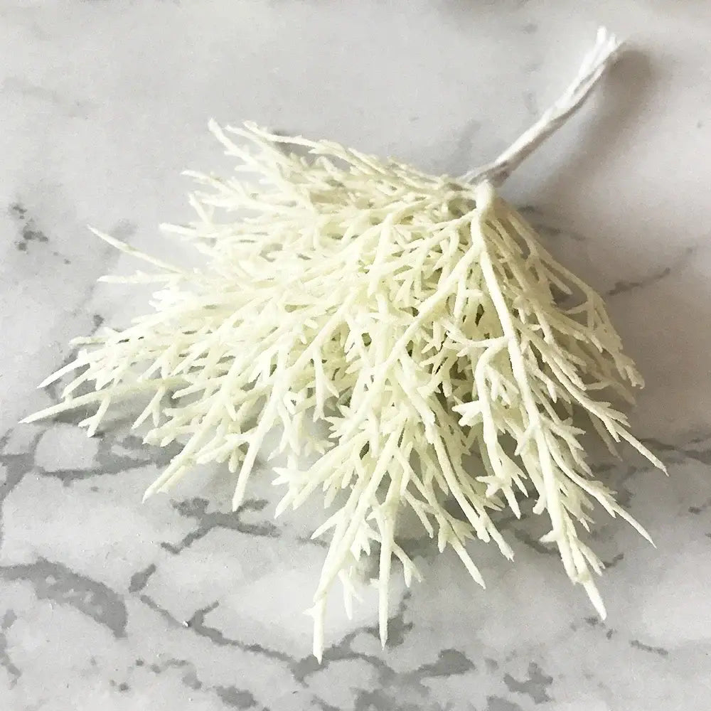 A delicate off-white decorbites ivory flower cherry artificial coral branch with fine tendrils and tied stem for wedding decor