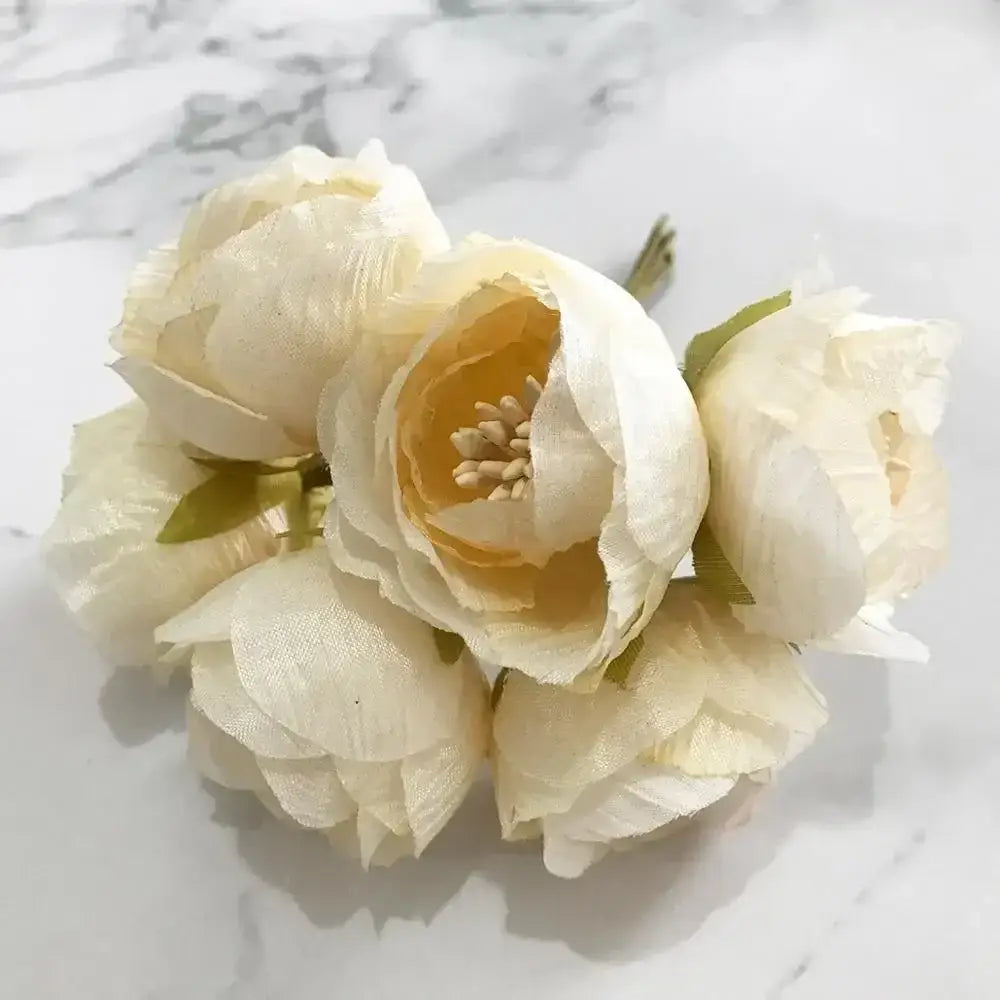A delicate cluster of decorbites ivory flower cherry with cream petals and flower cherry stamen for wedding decor