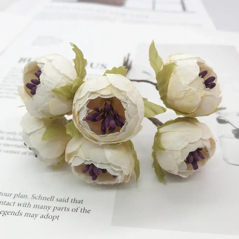 A cluster of decorbites ivory flower paper peonies with ivory flower cherry stamen and green fabric leaves for wedding decor