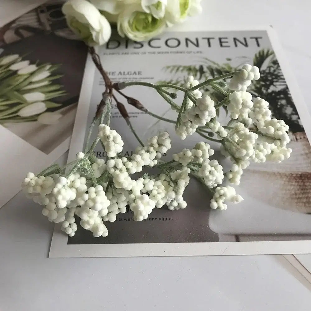 A delicate cluster of decorbites ivory flower cherry stamen berries with slender green stems for wedding decor