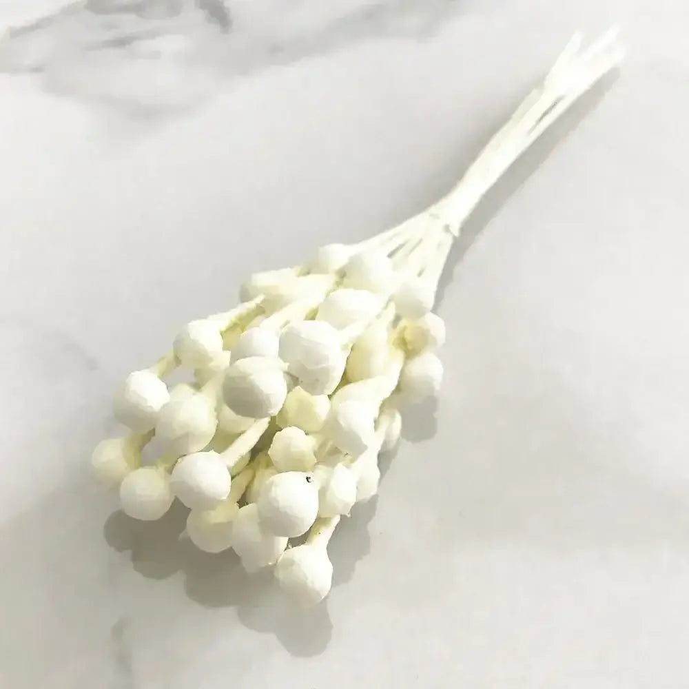 A delicate bundle of decorbites ivory flower cherry stamen berries in white for wedding and living room decor