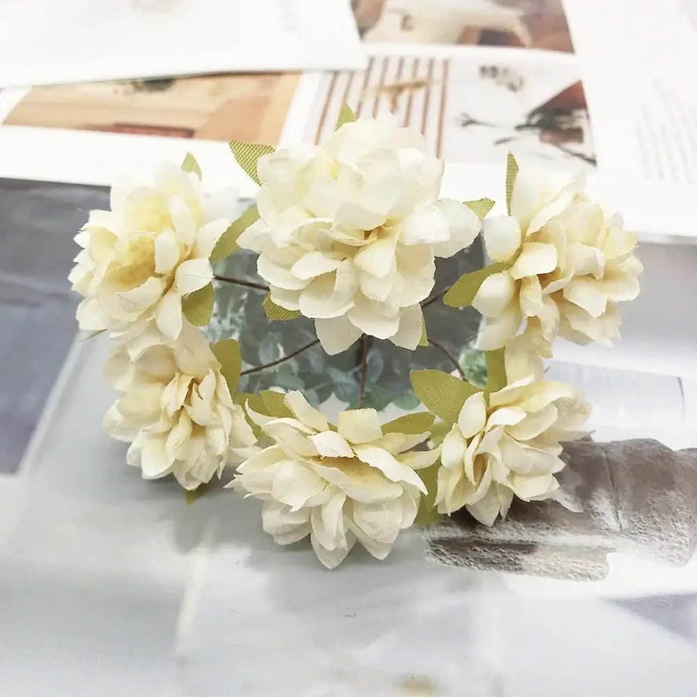 A cluster of decorbites ivory flower cherry stamen cream-colored artificial flowers with green fabric leaves for wedding decor