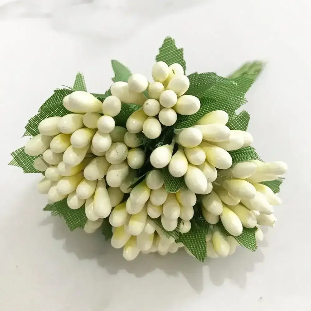 A cluster of decorbites ivory flower cherry stamen berries with green mesh leaves for wedding decor or living room display