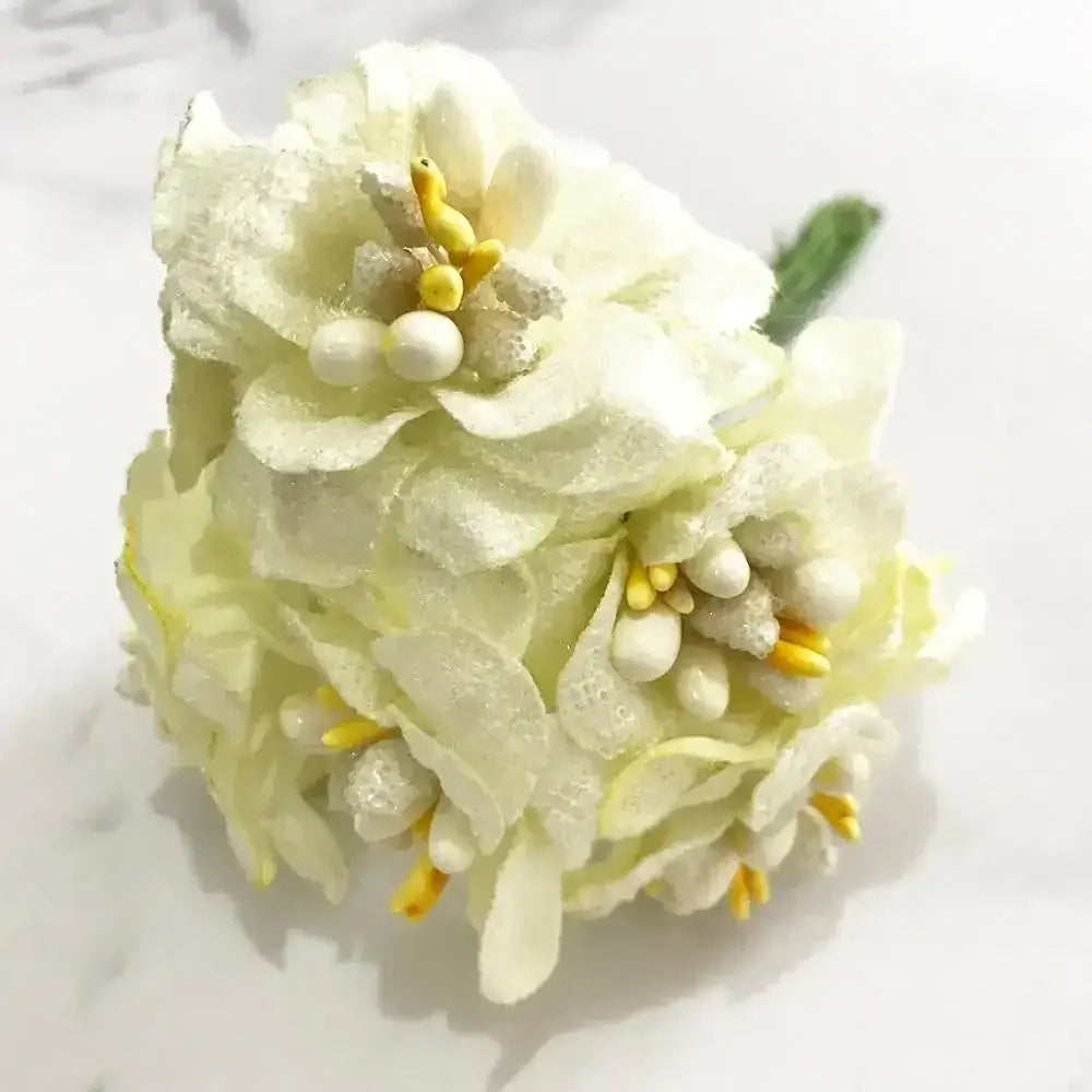 A delicate decorbites ivory flower cherry bouquet with layered petals yellow stamens and pearl accents for wedding decor