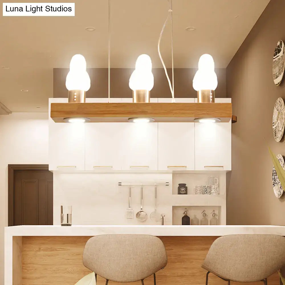 Decorbites ivory glass bird island pendant lighting fixture with frosted glass shades and brushed brass bases on wood bar