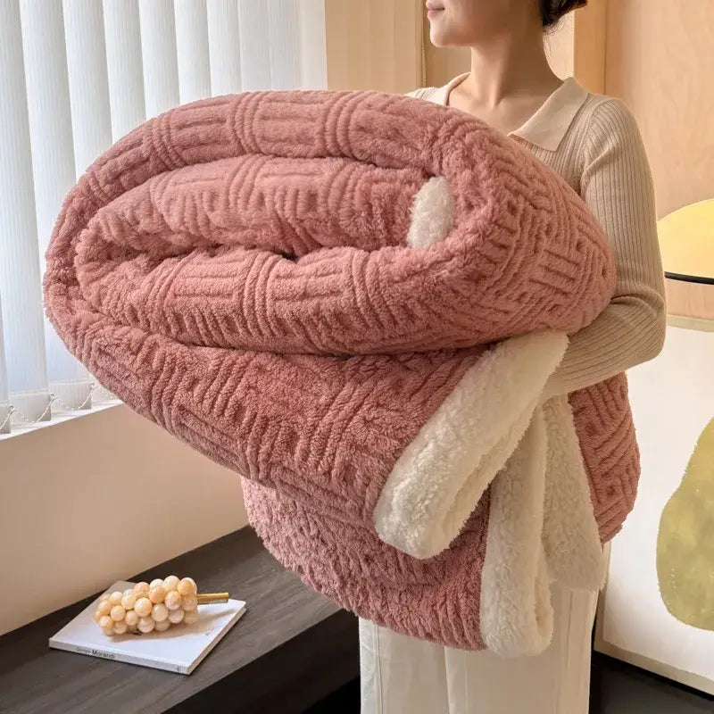 A plush pink quilted blanket with soft white fleece lining from decorbites jacquard lamb wool collection for cozy comfort