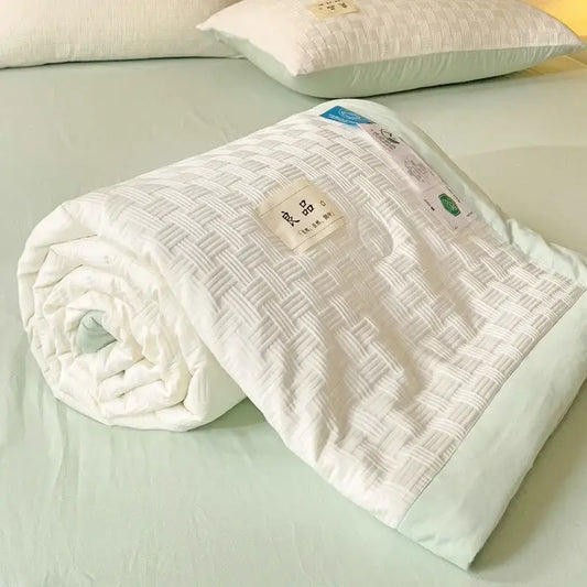 White decorbites jacquard summer cool blanket with subtle woven texture and light green piping edges for bedroom use