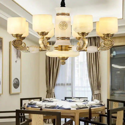 Gold-toned decorbites jade copper chandelier with ornate metalwork and frosted opal glass shades for living room use