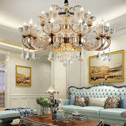 An ornate decorbites jade crystal multi-tiered chandelier with gold-toned metalwork and clear crystal accents