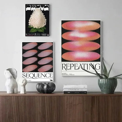 Three framed minimalist posters featuring japanese abstract blue wave and pink gradient designs hang above a wooden cabinet