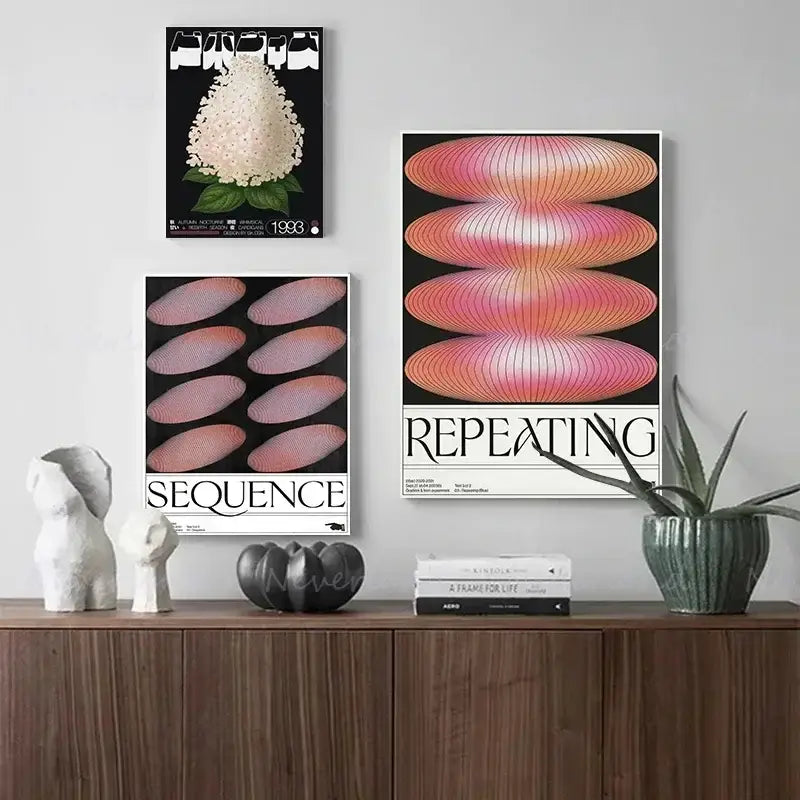 Three framed minimalist posters featuring japanese abstract blue wave and pink gradient designs hang above a wooden cabinet