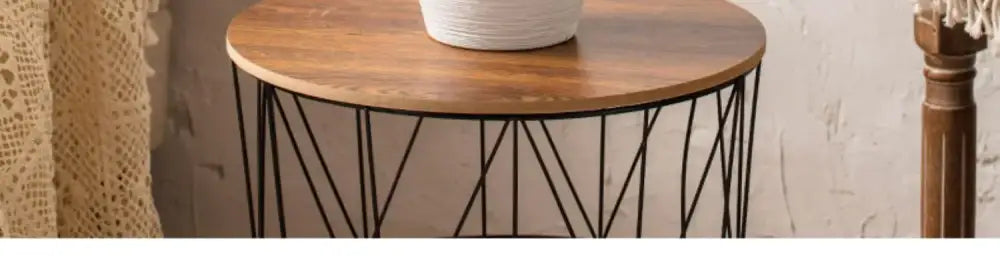 Round wooden table with black metal geometric legs complementing a japanese minimalist hydroponic vase set decorbites