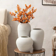 Three white ceramic hydroponic vases with textured ribbed surfaces on a wooden table from decorbites japanese minimalist hydroponic vase set