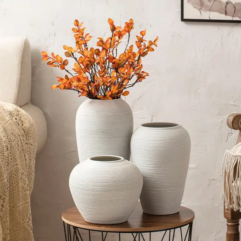 Three white ceramic hydroponic vases with textured ribbed surfaces on a wooden table from decorbites japanese minimalist hydroponic vase set