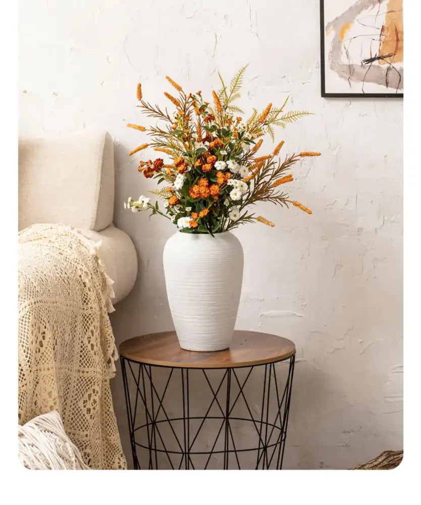 White textured ceramic hydroponic vase from DecorBites™ holding orange white and brown artificial flowers minimalist hydroponic vase