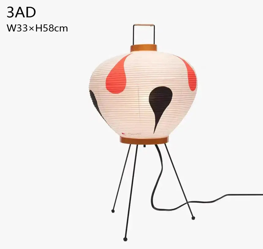 Cream-colored decorbites japanese style paper floor lamp with red and black teardrop patterns on minimalist tripod base