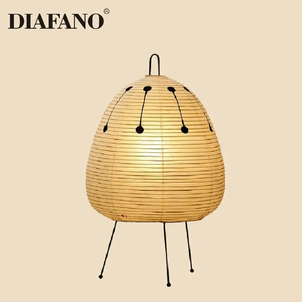 A warm beige decorbites japanese style paper floor lamp with black wire accents and tripod base for living room lighting
