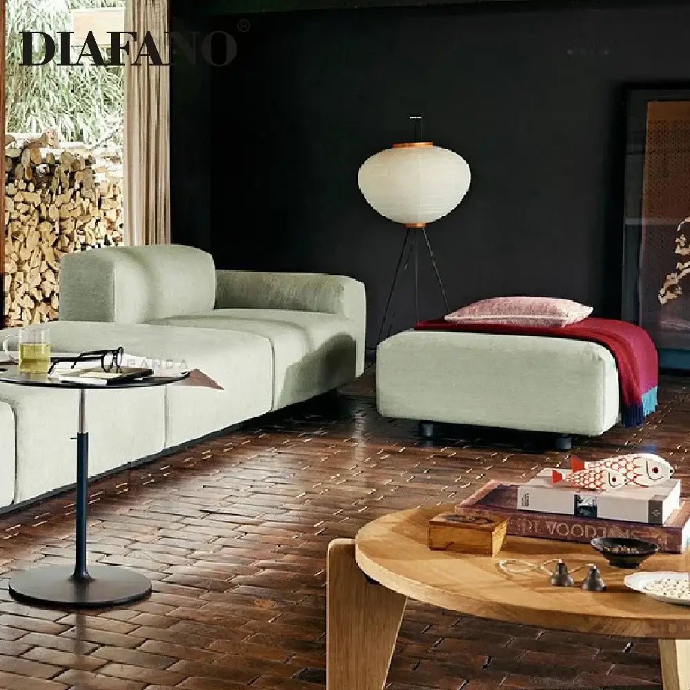 Light green modular sofa with soft upholstered cushions paired with decorbites japanese style paper floor lamp for living room lighting