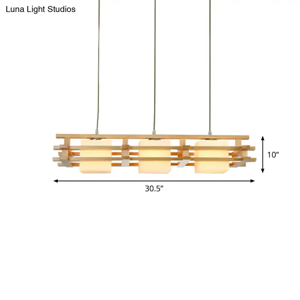 Modern wooden pendant light with three warm-toned blown glass shades, minimalist design ideal for cube restaurant islands