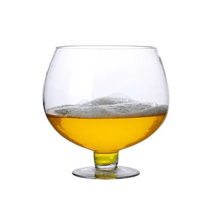 A clear glass decorbites jumbo party glass filled with golden beer and topped with a frothy white head