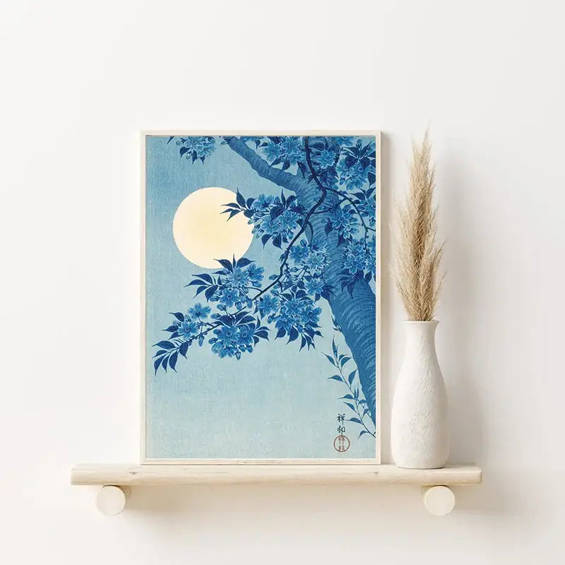 Blue and white framed print of cherry blossoms under a full moon in katsushika hokusai blue waves style wall art
