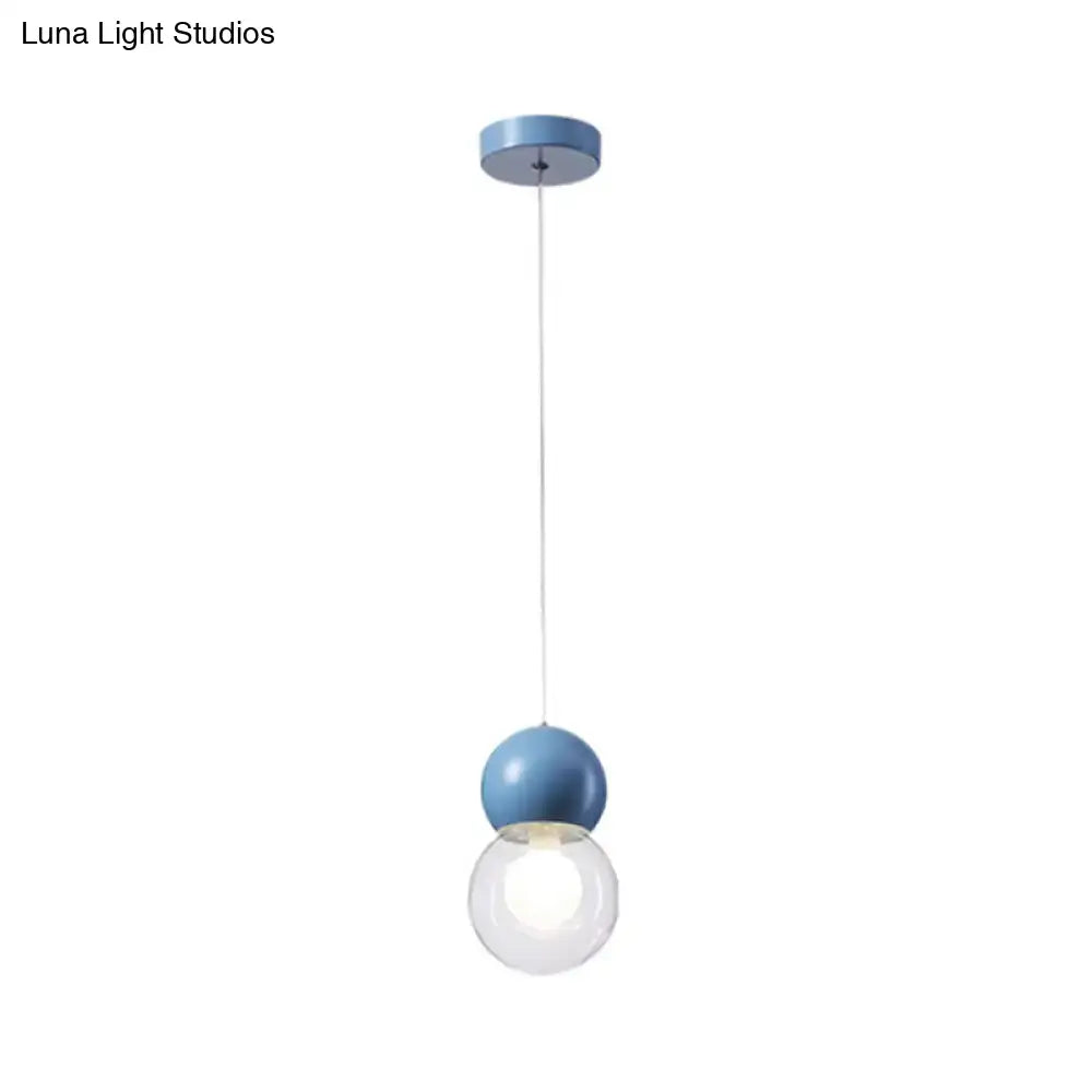 Blue spherical kids bedside pendulum light with clear glass globe and milky macaron ceiling pendant design