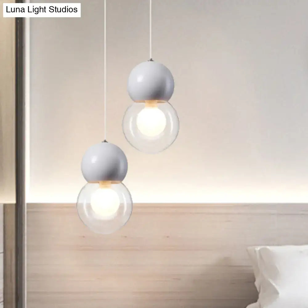 Modern white spherical kids bedside pendulum lights with clear glass globes and thin cords from decorbites macaron ceiling pendant