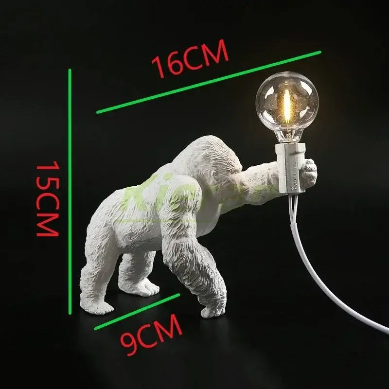 White ceramic decorbites king kong led desk lamp in black resin featuring a glowing filament bulb for living room use