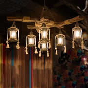 Rustic wooden DecorBites™ lantern restaurant island light with five clear glass lanterns featuring beige rope and tassels compatible with led incandescent fluorescent bulbs
