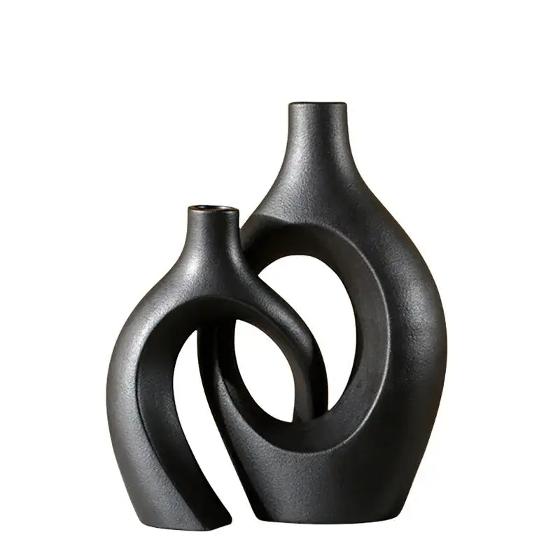 Two interlocking black matte ceramic vases with smooth curved surfaces large 21cm for home decor by DecorBites™