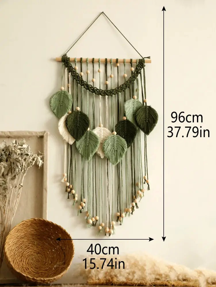 Green macrame wall hanging with leaf-shaped woven accents and wooden beads for boho home decor by DecorBites