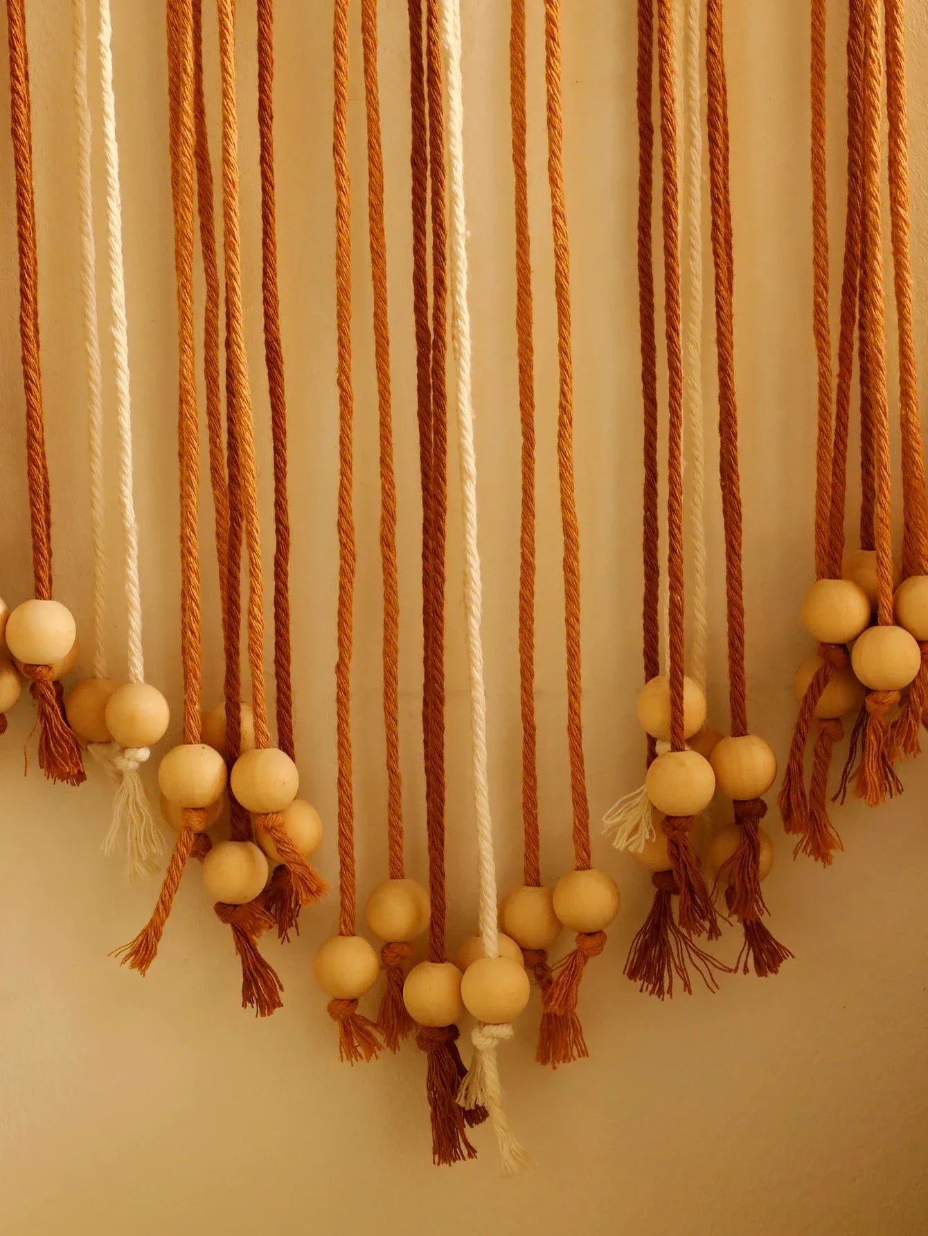 Decorbites™ leaf macrame wall hanging with natural wooden beads and warm orange and cream woven cords for boho decor