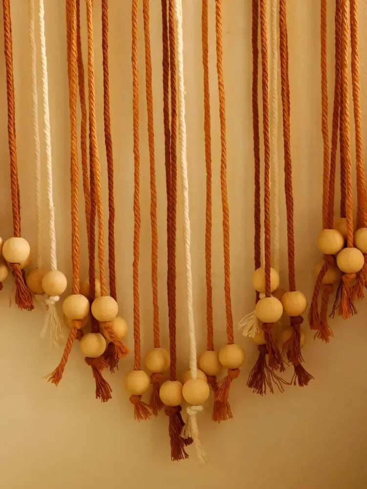 Decorbites™ leaf macrame wall hanging with natural wooden beads and warm orange and cream woven cords for boho decor