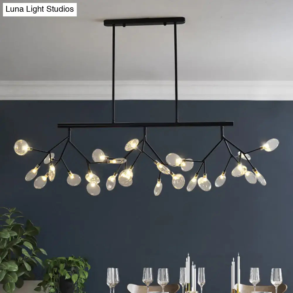 Black metal leaf-shaped island chandelier with branching arms holding clear glass globe bulbs compatible with 110v-240v