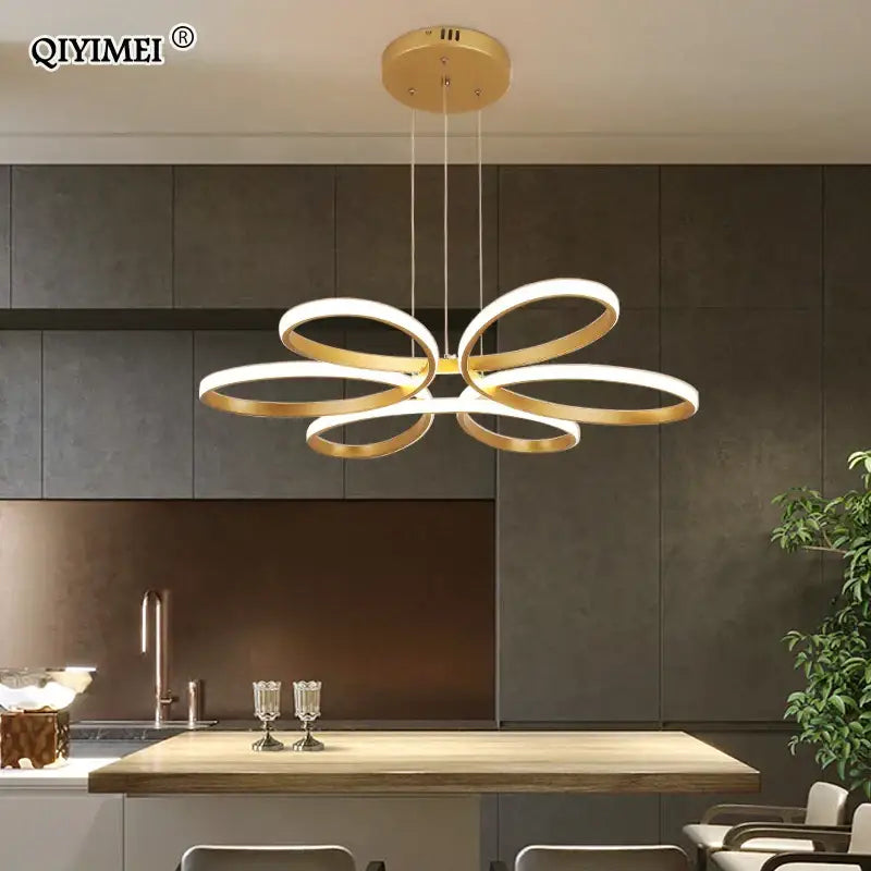 Gold-toned decorbites led ceiling light featuring a modern flower-like design with interlocking rings for living rooms