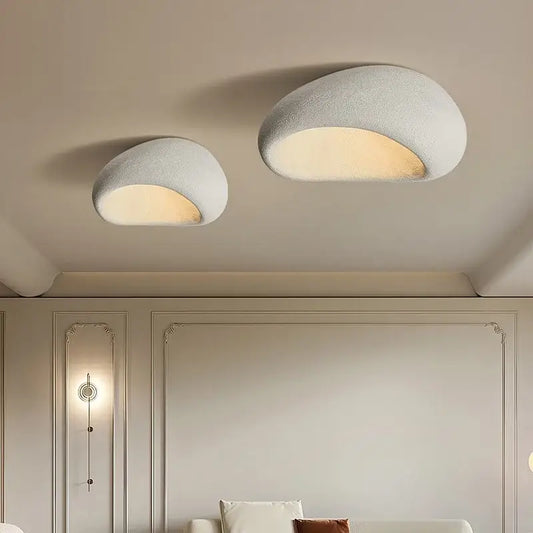 Two off-white decorbites led ceiling lights with textured shell design emit warm illumination for bedroom and living room