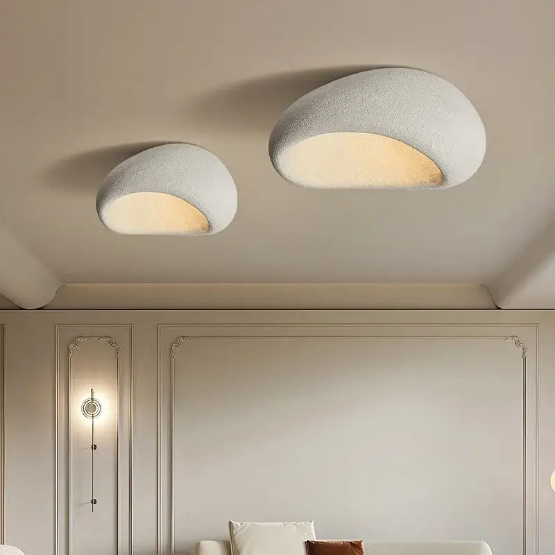 Two off-white decorbites led ceiling lights with textured shell design emit warm illumination for bedroom and living room