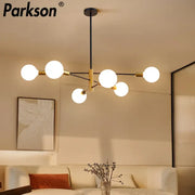 Parkson brand modern decorbites led ceiling light features five frosted glass bulbs on a black and brass metal frame