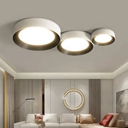 Modern white decorbites led ceiling lights with three circular lamps and ribbed metallic rims for indoor use