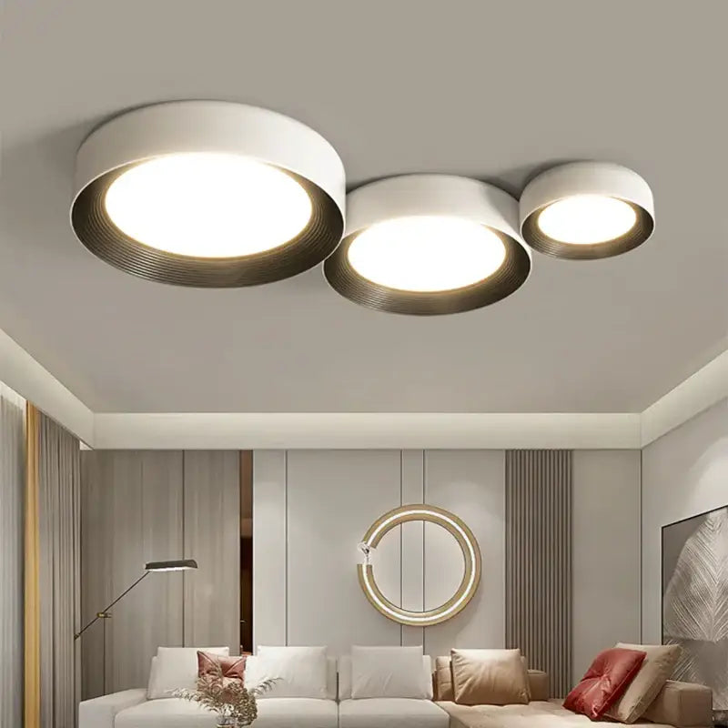 Modern white decorbites led ceiling lights with three circular lamps and ribbed metallic rims for indoor use