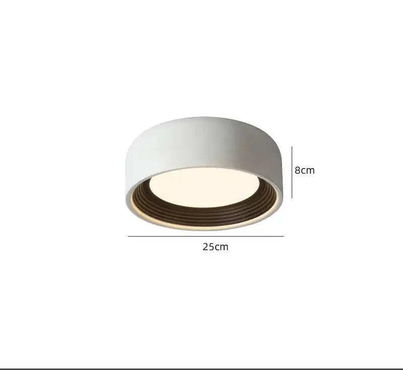 White cylindrical decorbites led ceiling light with warm glow and concentric ridges for modern home lighting