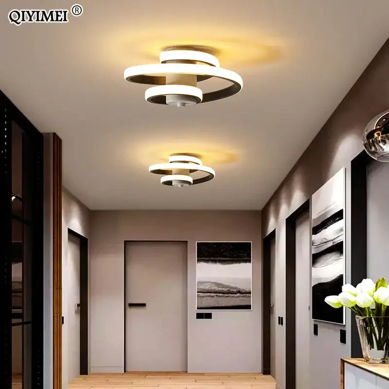 Modern spiral decorbites led ceiling light with white and black concentric rings emitting warm ambient lighting