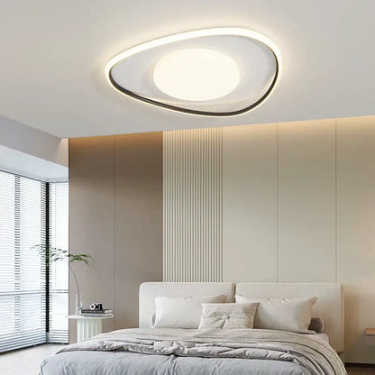 Modern oval decorbites led ceiling light with white and black frame emitting warm ambient glow for home lighting fixtures