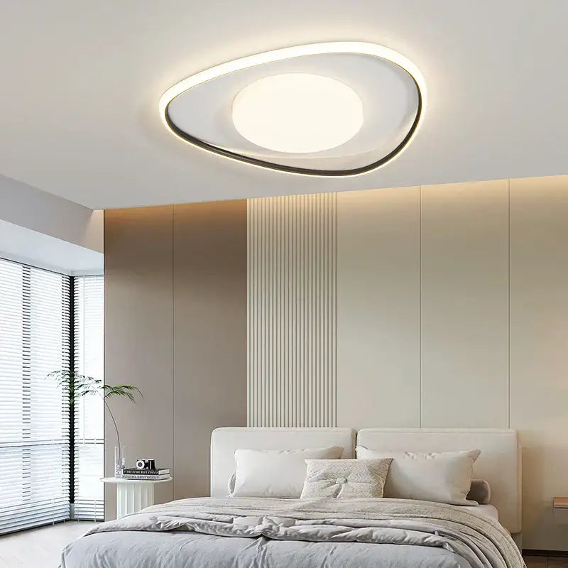 Modern oval decorbites led ceiling light with white and black frame emitting warm ambient glow for home lighting fixtures