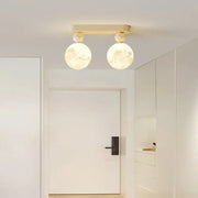 Modern decorbites led ceiling fixture with two illuminated moon globes and cream rectangular bar for minimalist lighting
