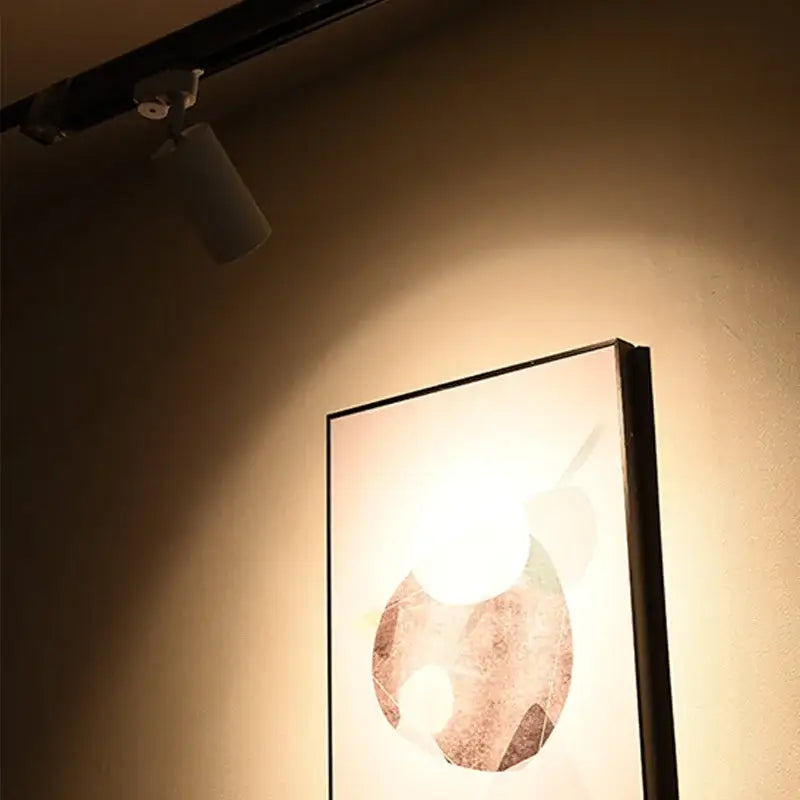 Decorbites led ceiling spotlight illuminating a modern minimalist framed artwork with textured abstract earth tones design
