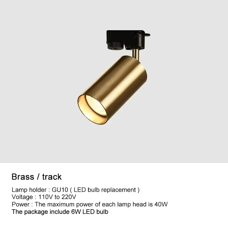 A sleek brass decorbites led ceiling spotlight with cylindrical polished finish and black mounting bracket for modern spaces