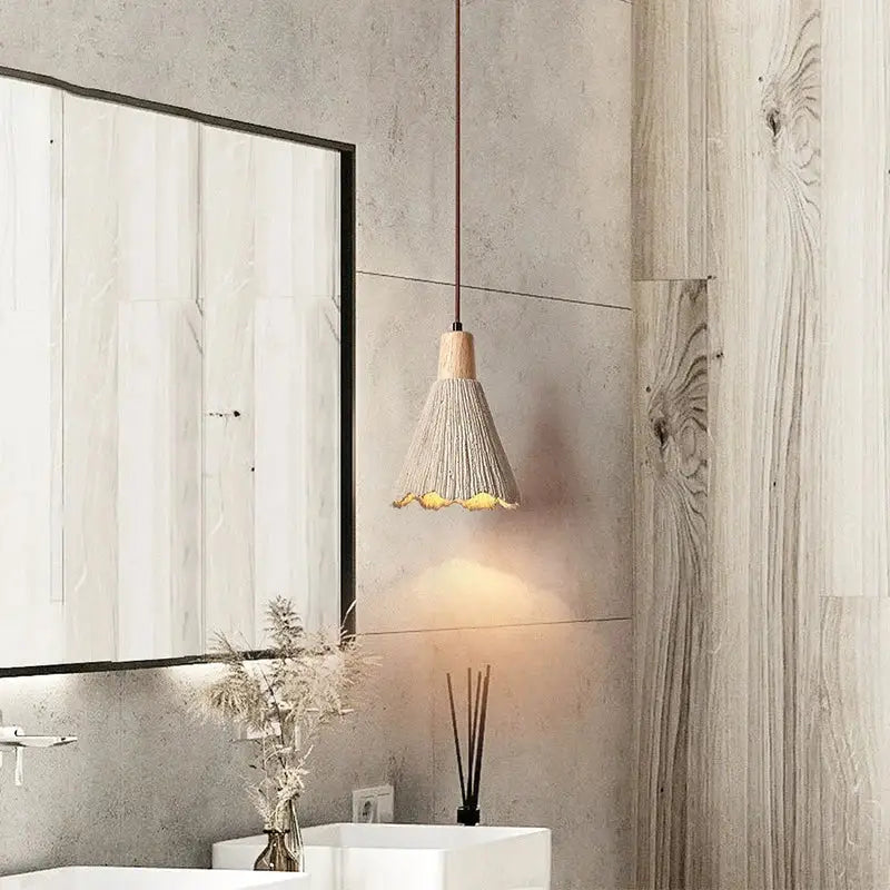 A warm-toned decorbites led cement pendant lamp with woven shade and natural wood top in creamy wabi-sabi style