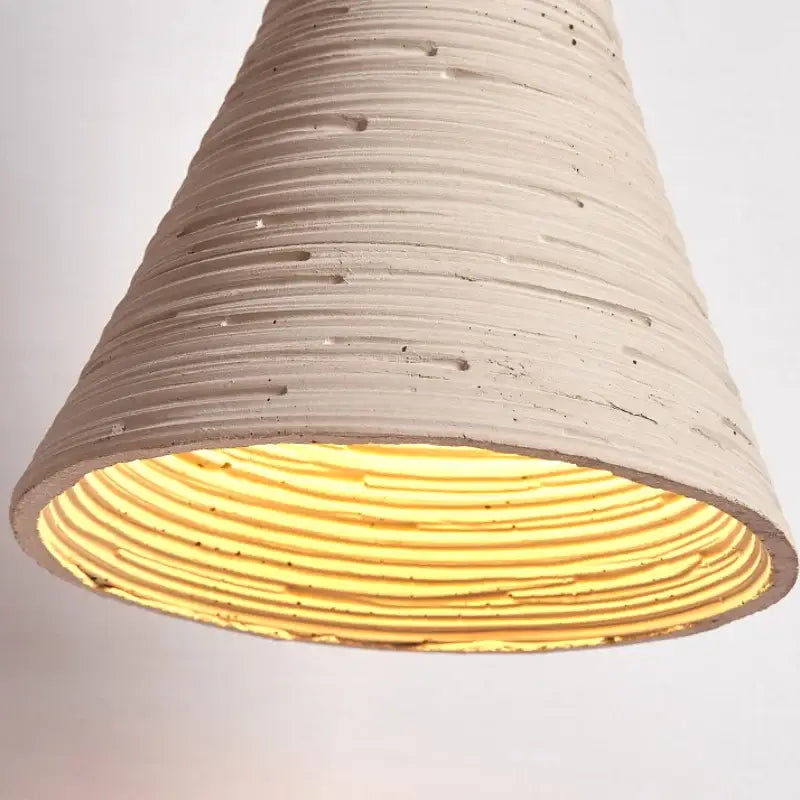 Beige ribbed concrete decorbites led cement wall light with warm yellow glow and wood socket pull chain nordic modern sconce